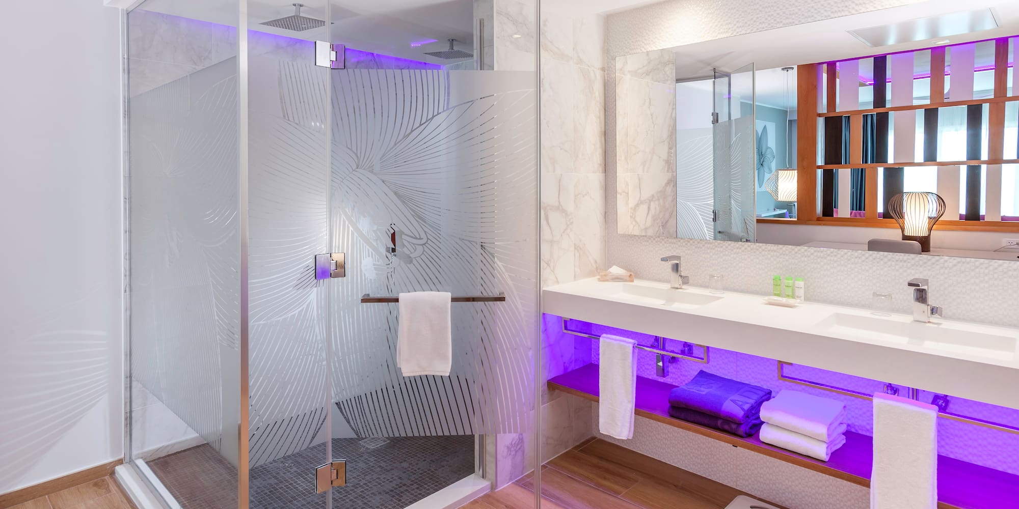a bathroom with a glass shower and a sink