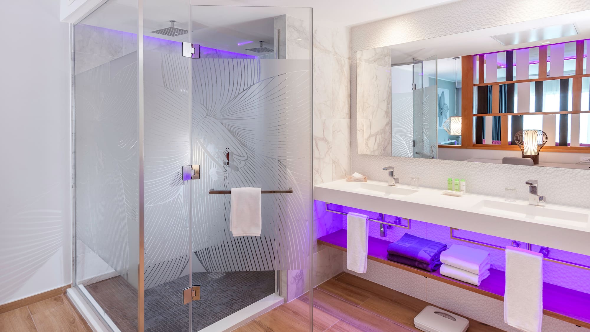 a bathroom with a glass shower and a sink