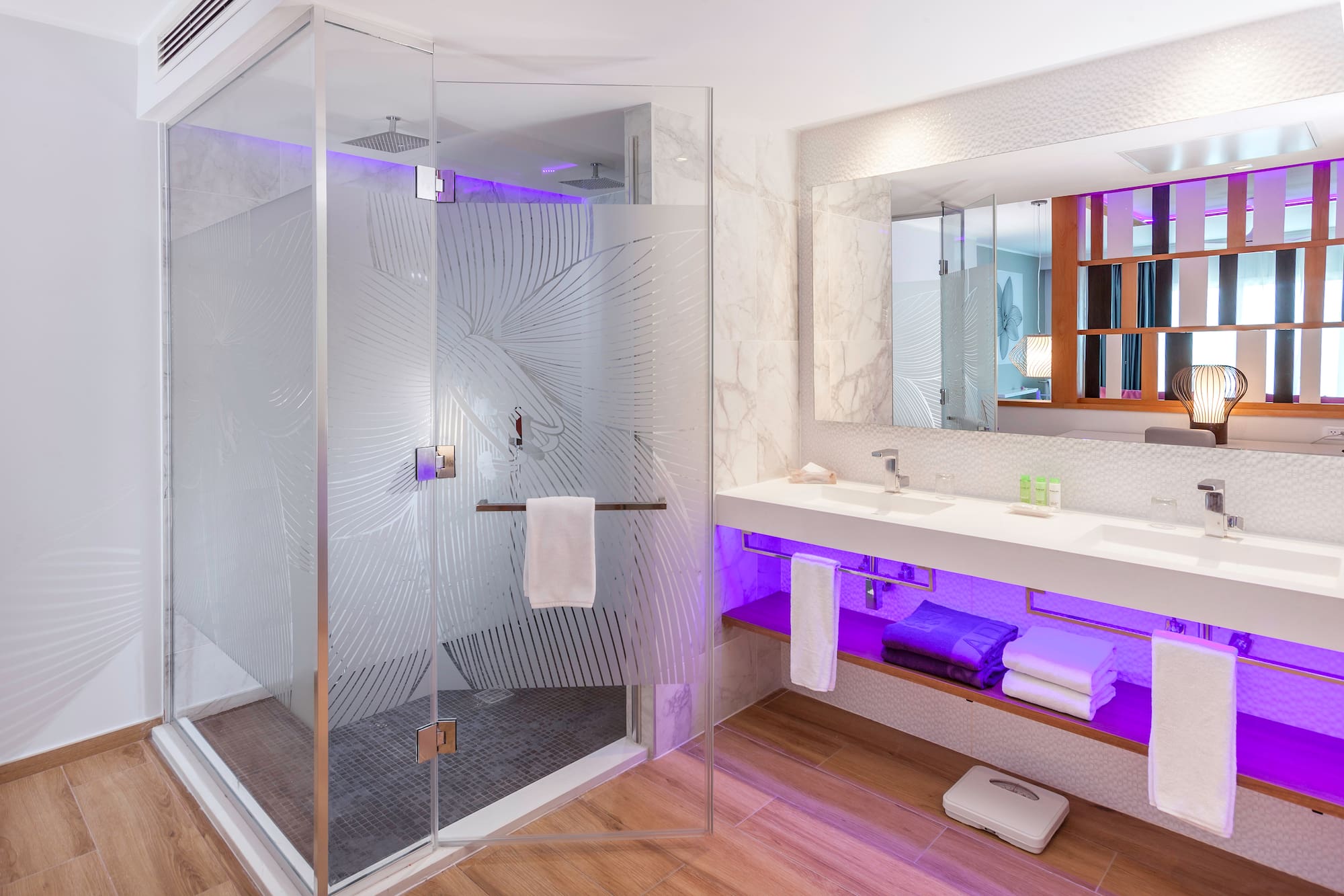 a bathroom with a glass shower and a sink