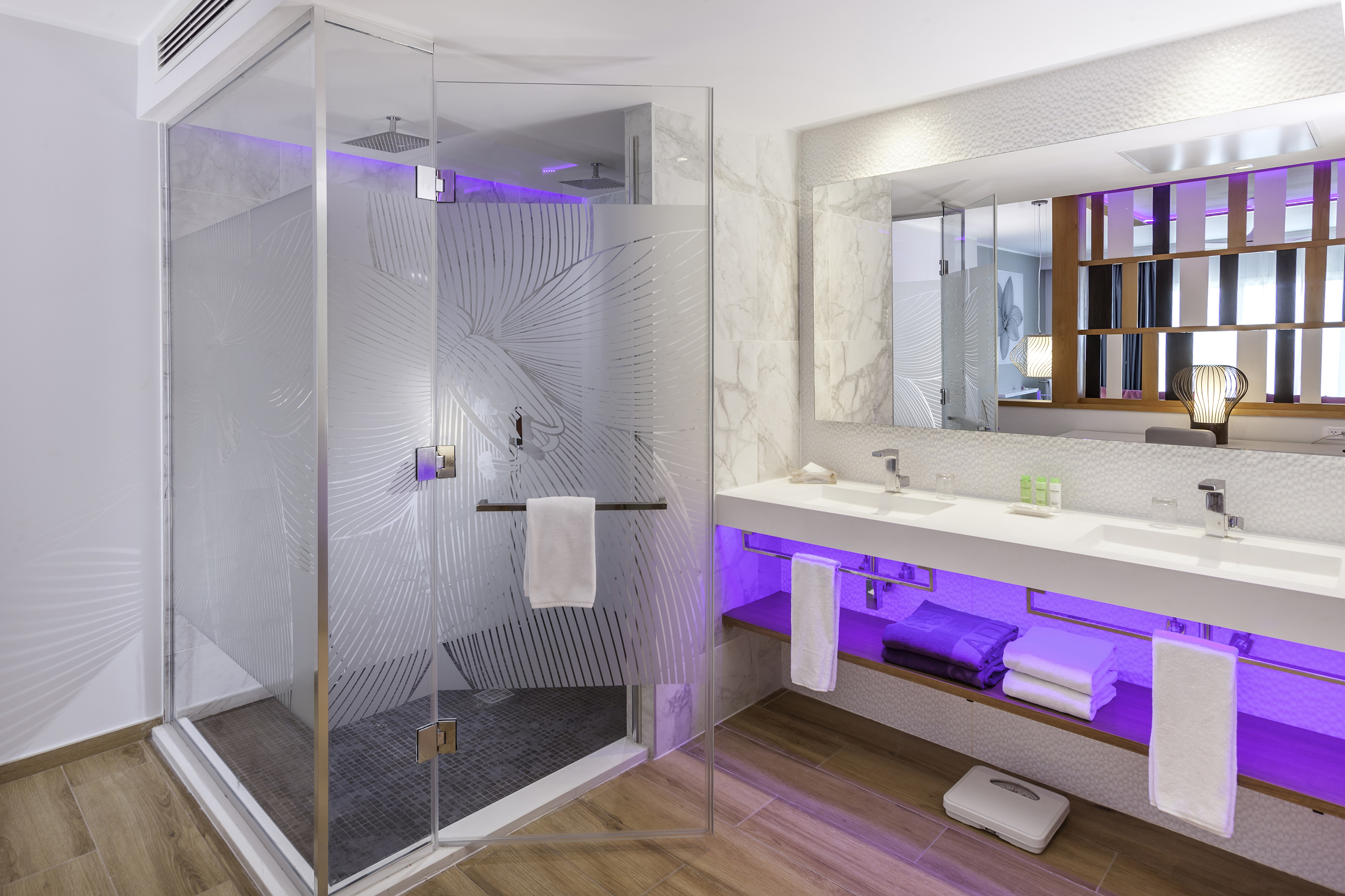 a bathroom with a glass shower and a sink