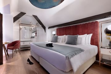 a bedroom with a bed and a mirror