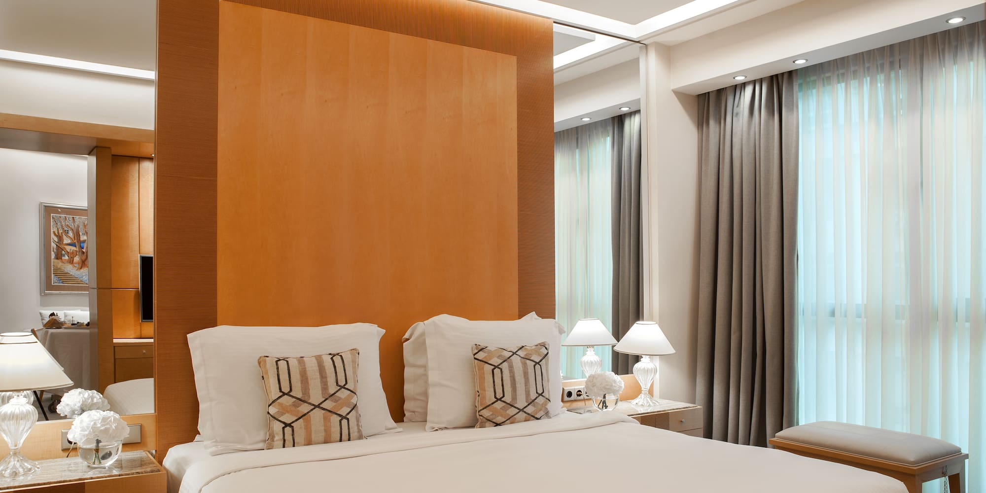 a bed with pillows and lamps in a room