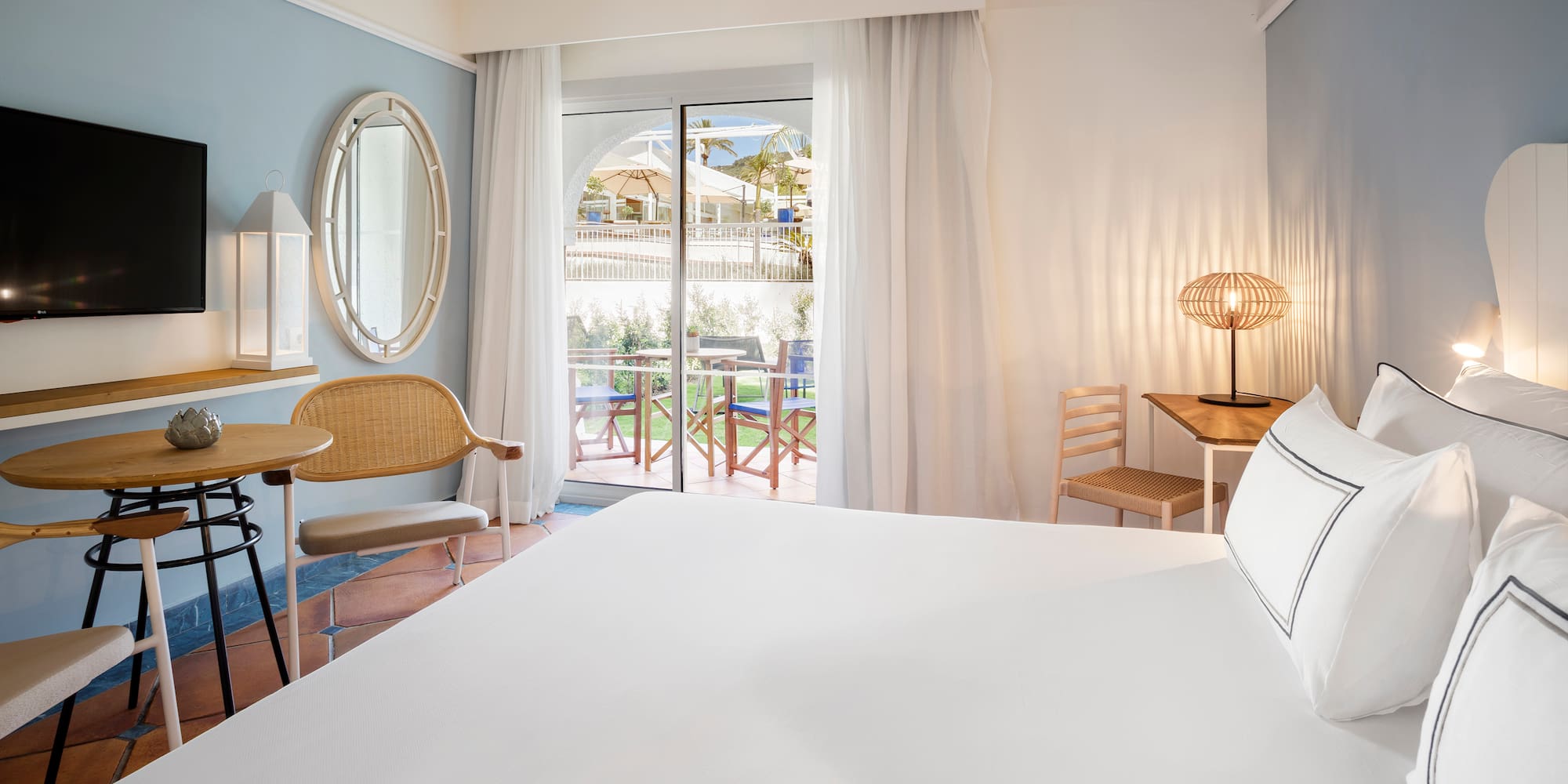 a room with a bed and chairs and a table