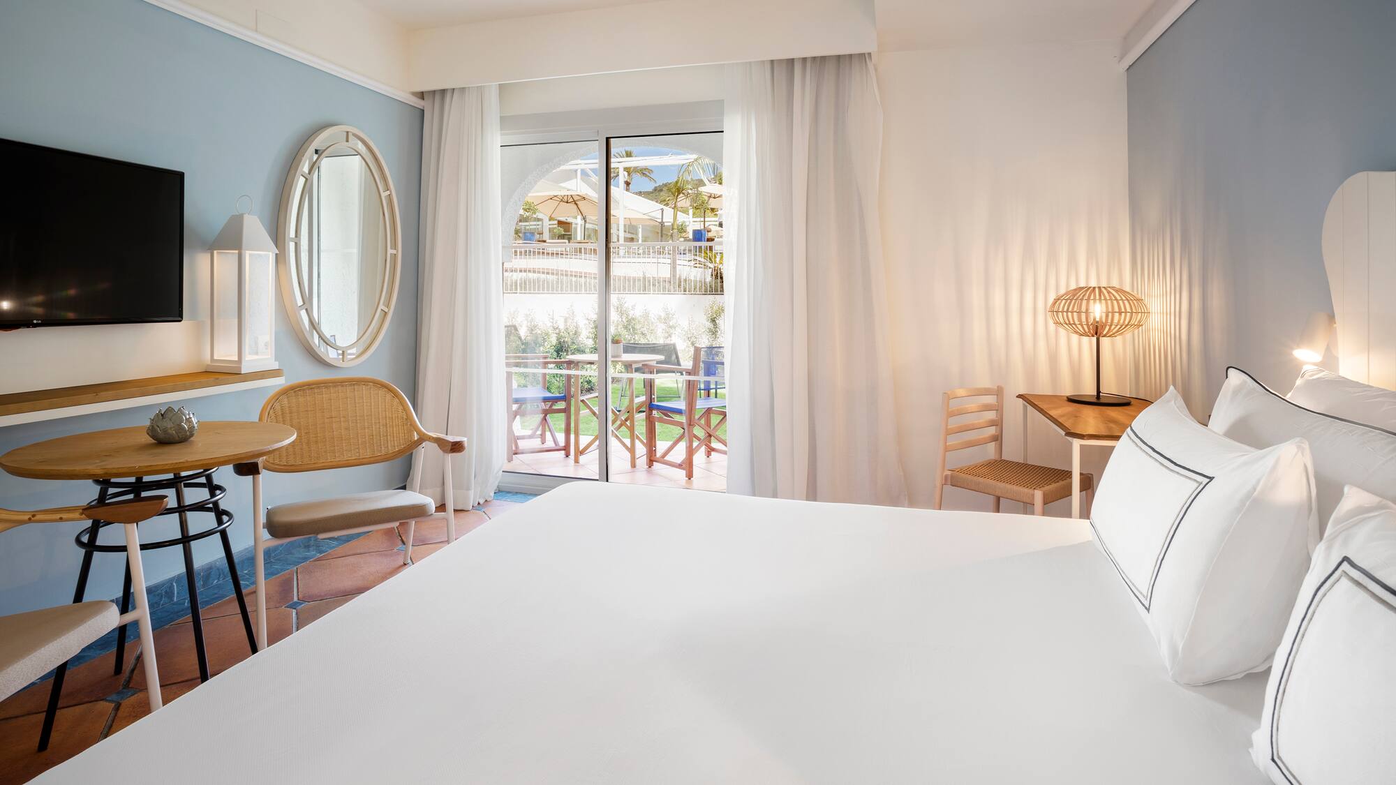 a room with a bed and chairs and a table