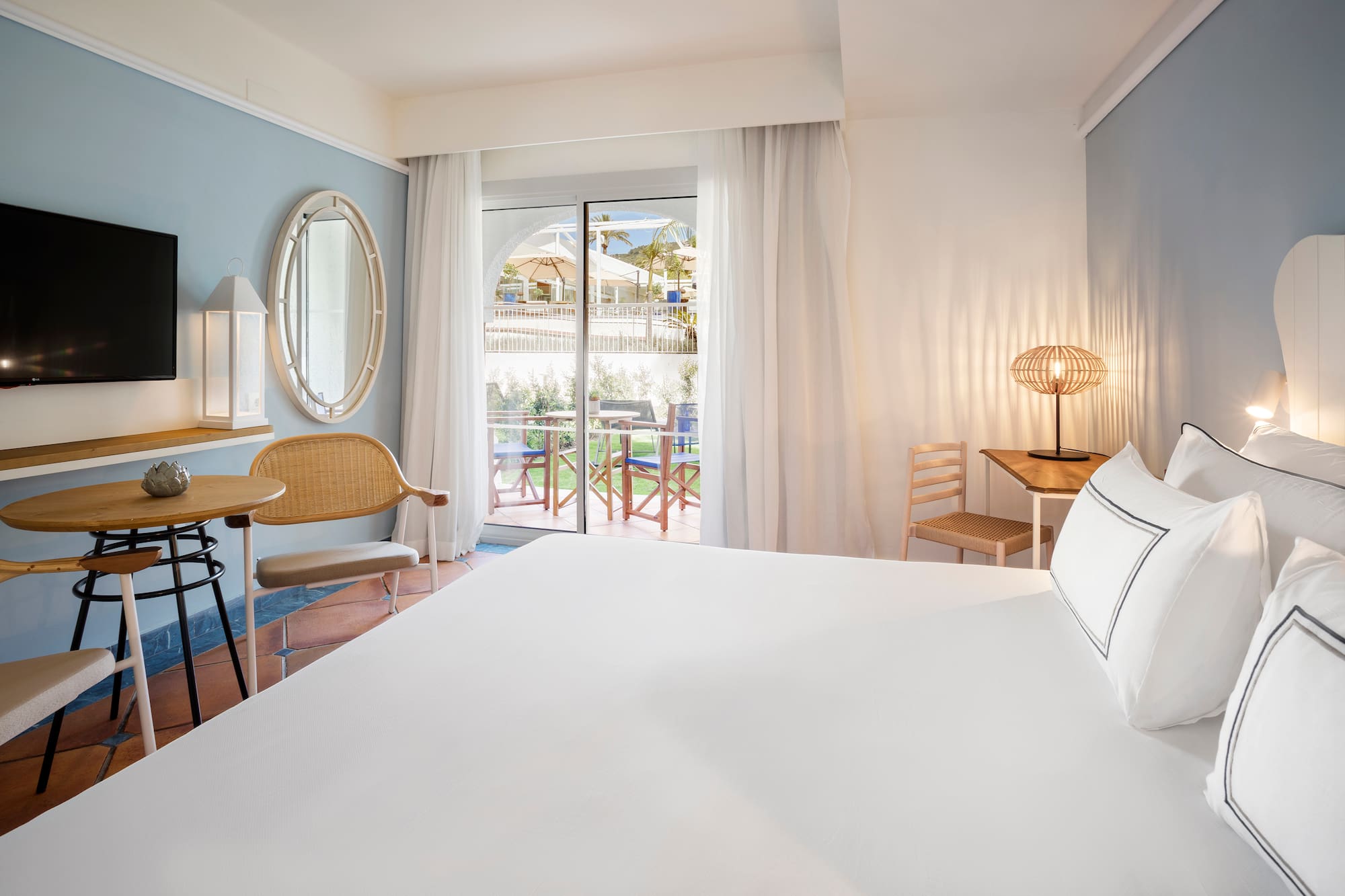 a room with a bed and chairs and a table