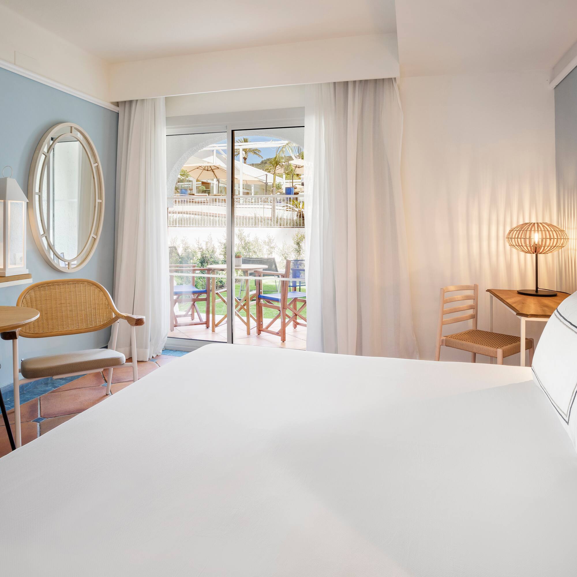 a room with a bed and chairs and a table