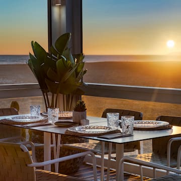a table set up on a balcony overlooking the ocean
