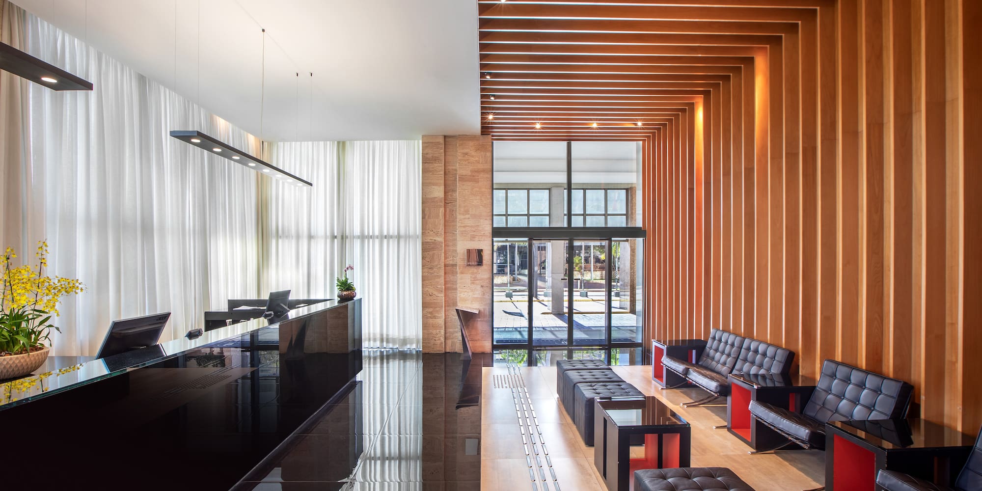 a lobby with a reception desk and chairs