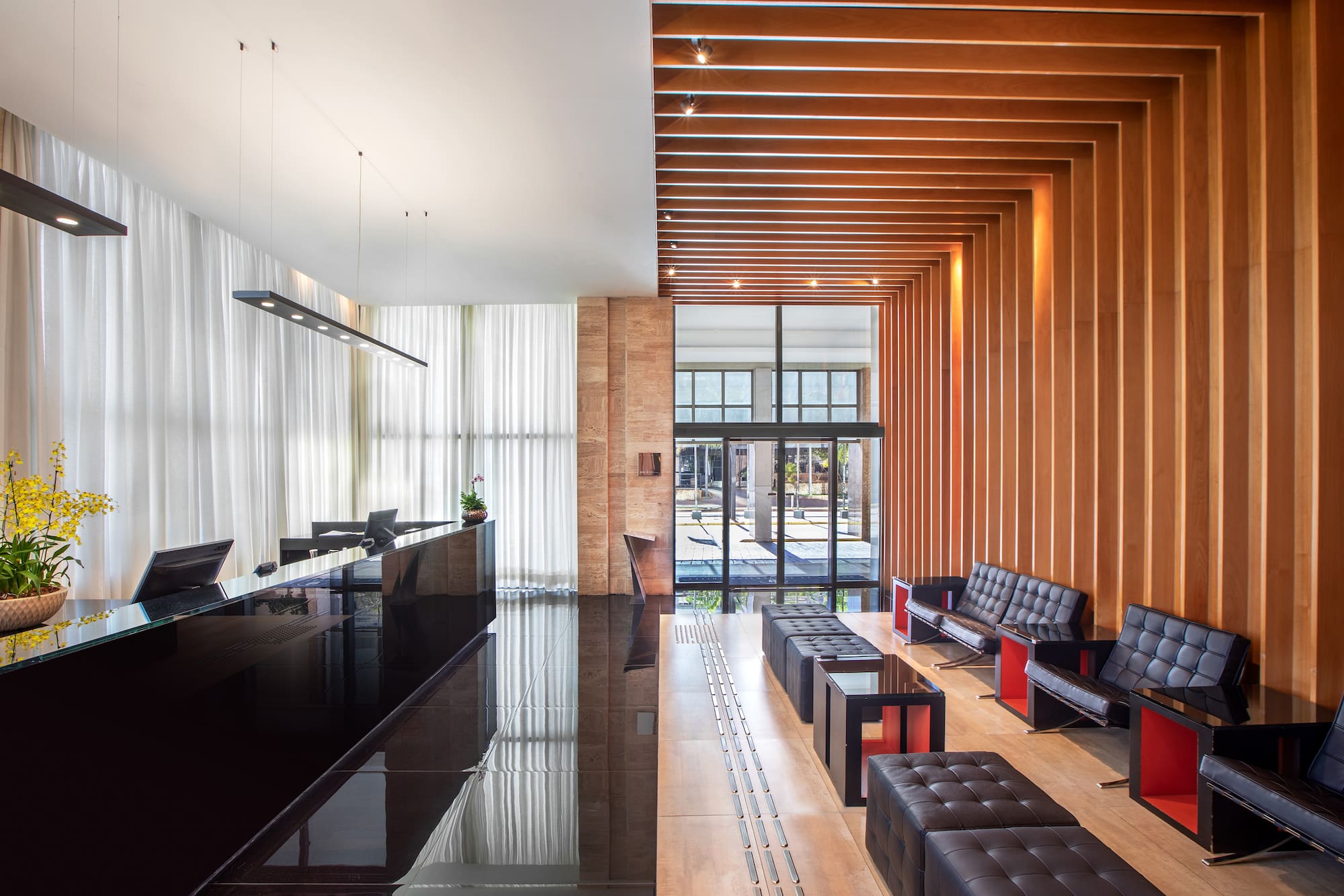 a lobby with a reception desk and chairs