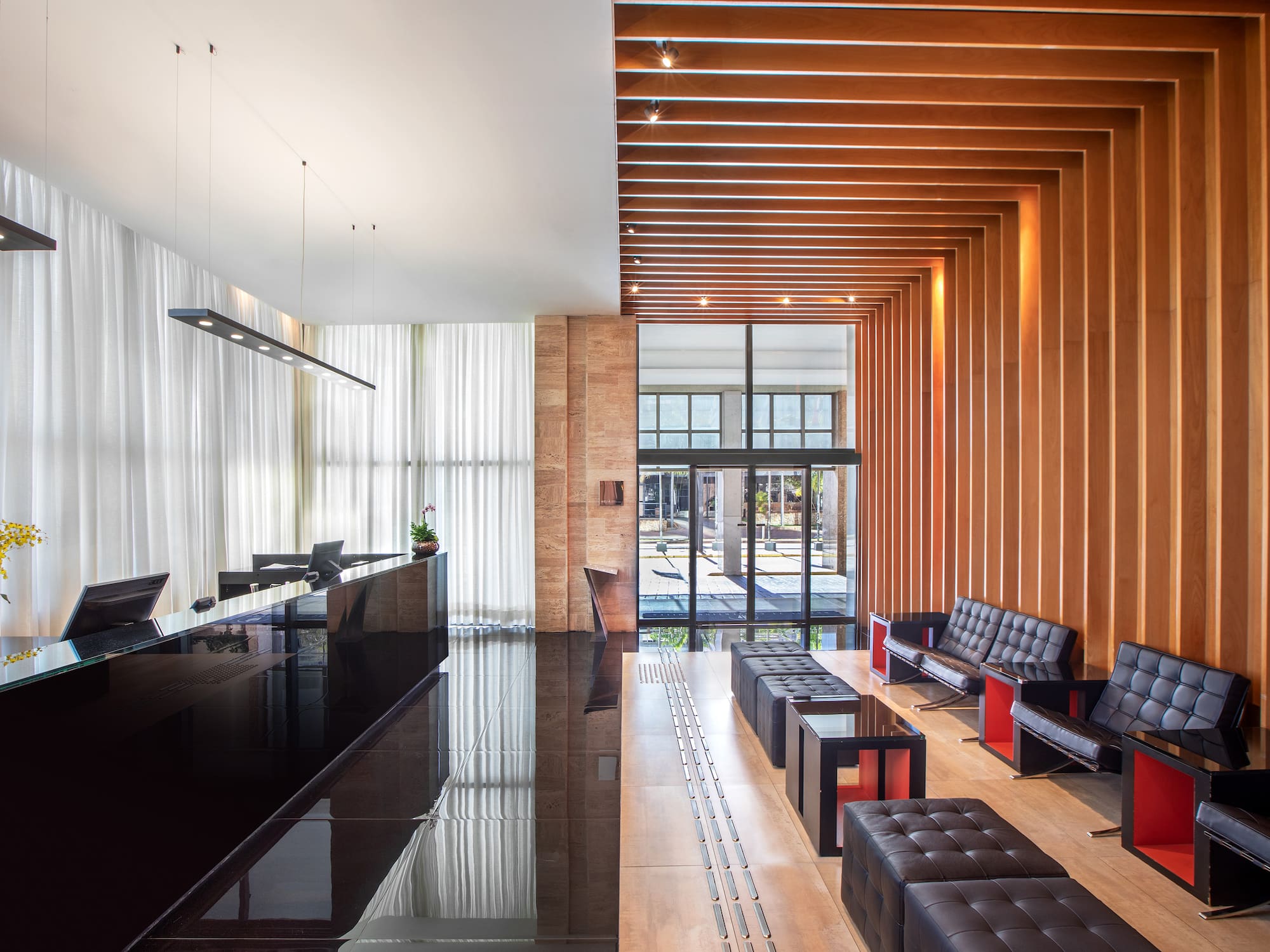 a lobby with a reception desk and chairs