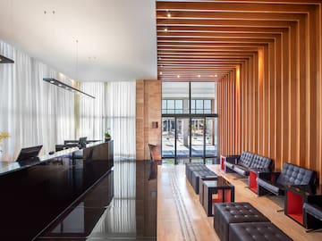 a lobby with a reception desk and chairs