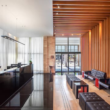 a lobby with a reception desk and chairs