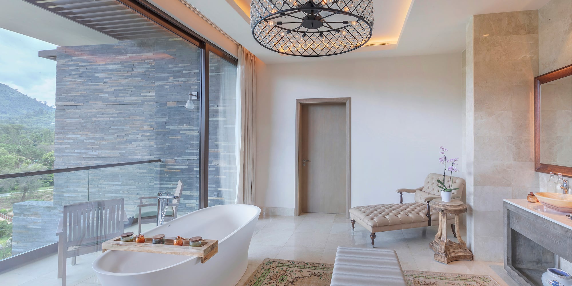 a bathroom with a tub and a chandelier