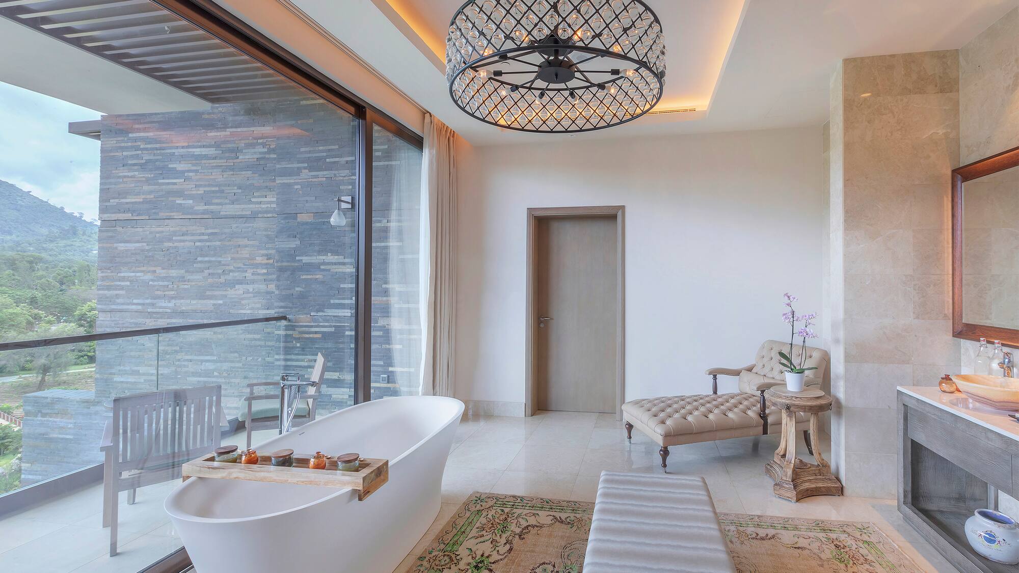 a bathroom with a tub and a chandelier