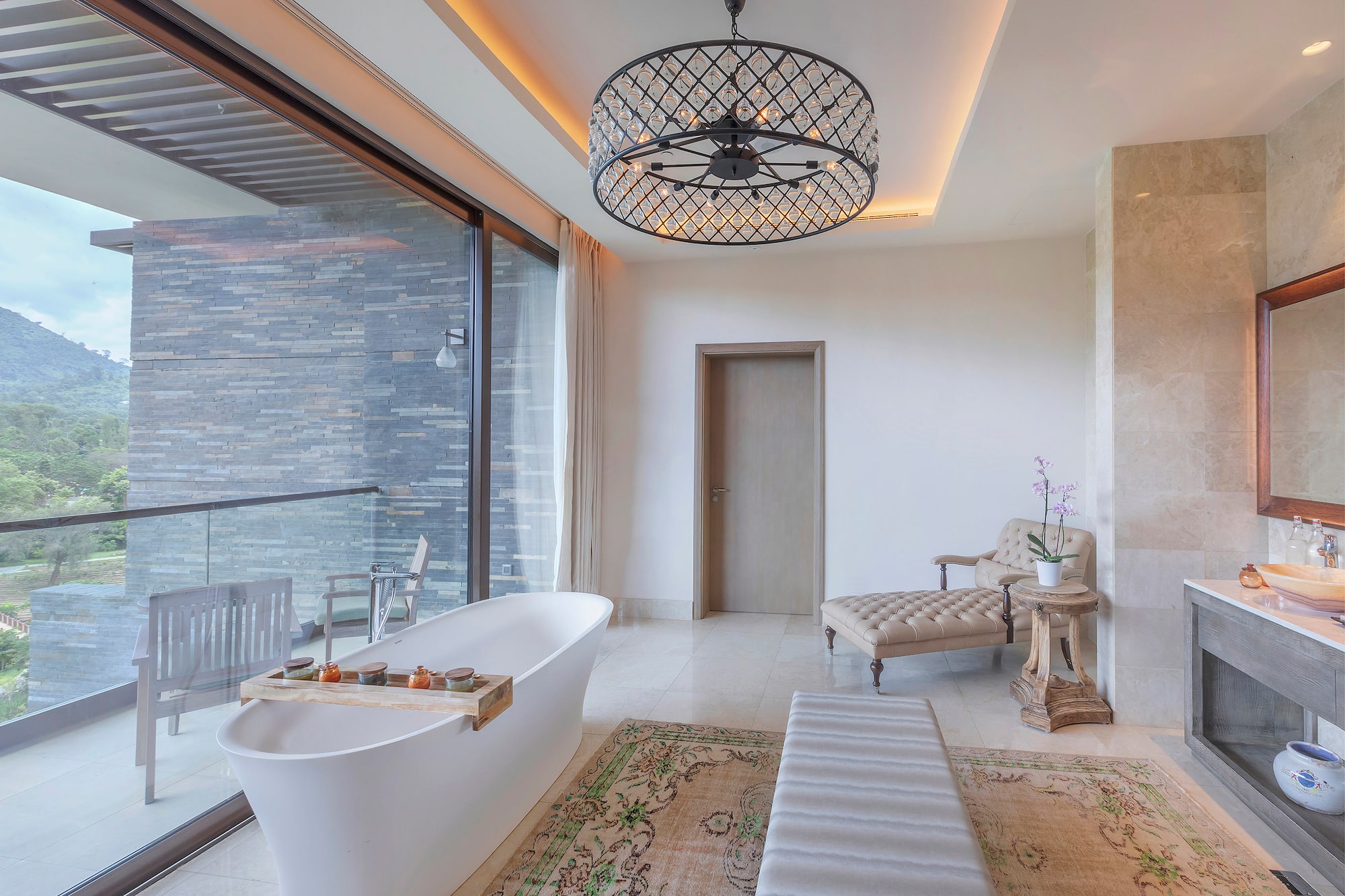 a bathroom with a tub and a chandelier