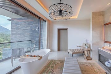 a bathroom with a tub and a chandelier
