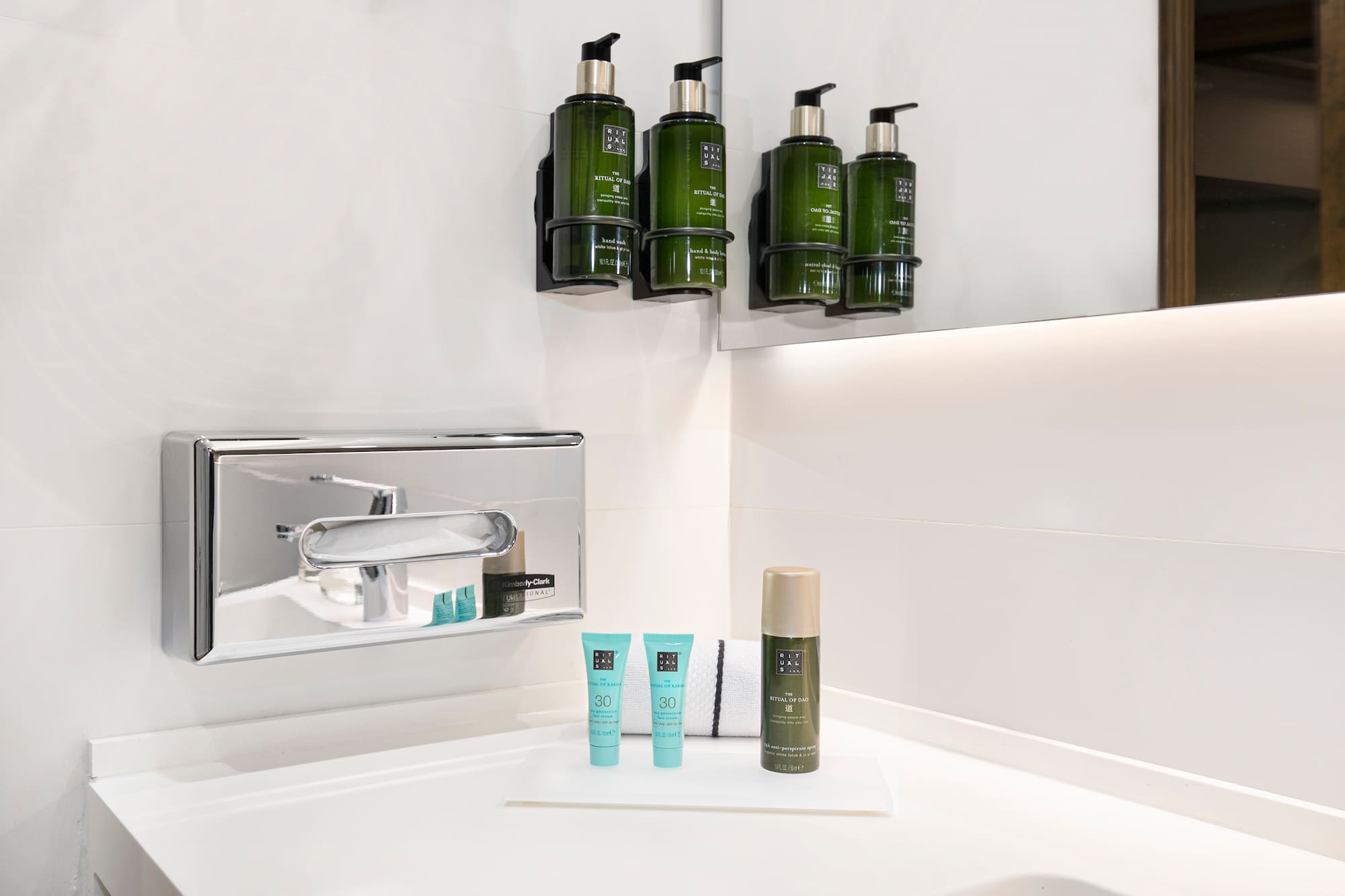 a bathroom with a sink and a group of green bottles