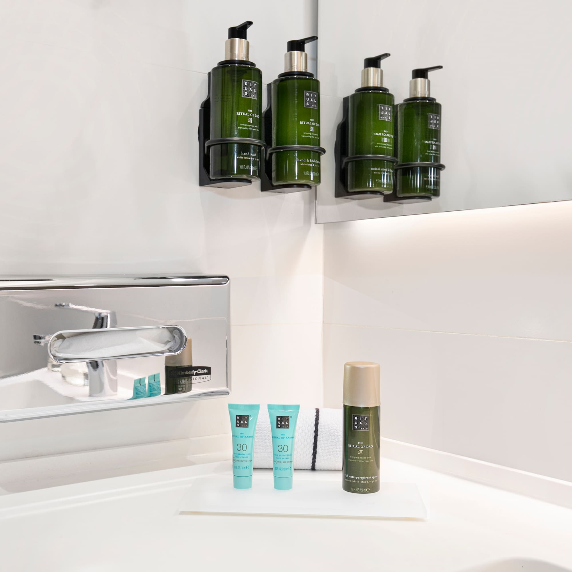 a bathroom with a sink and a group of green bottles