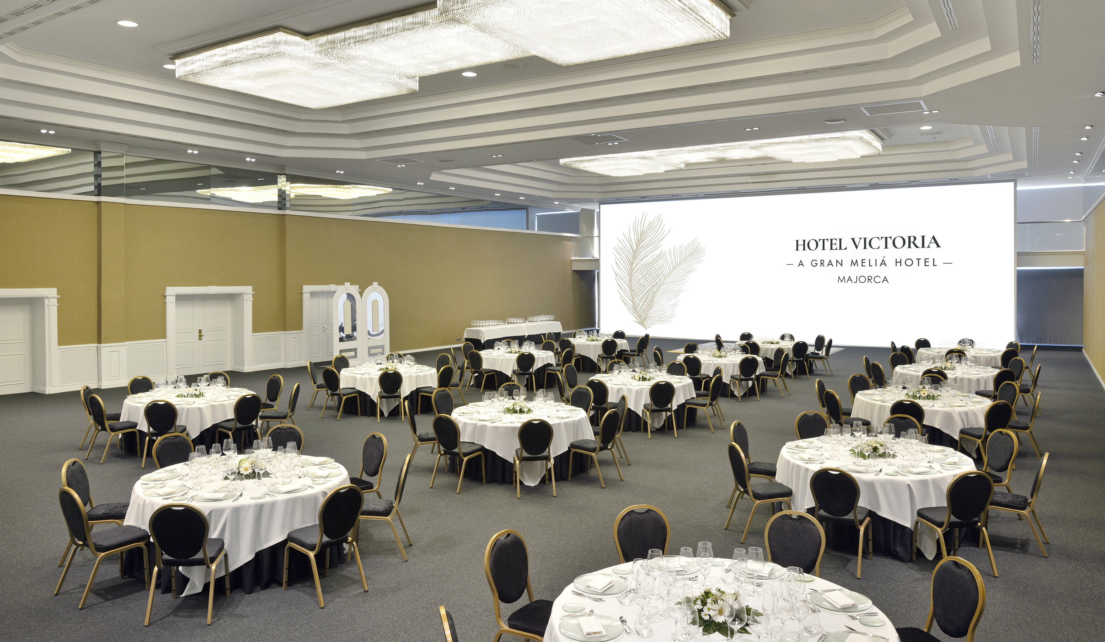 Hotel Victoria Majorca event ballroom with round banquet tables set for guests.
