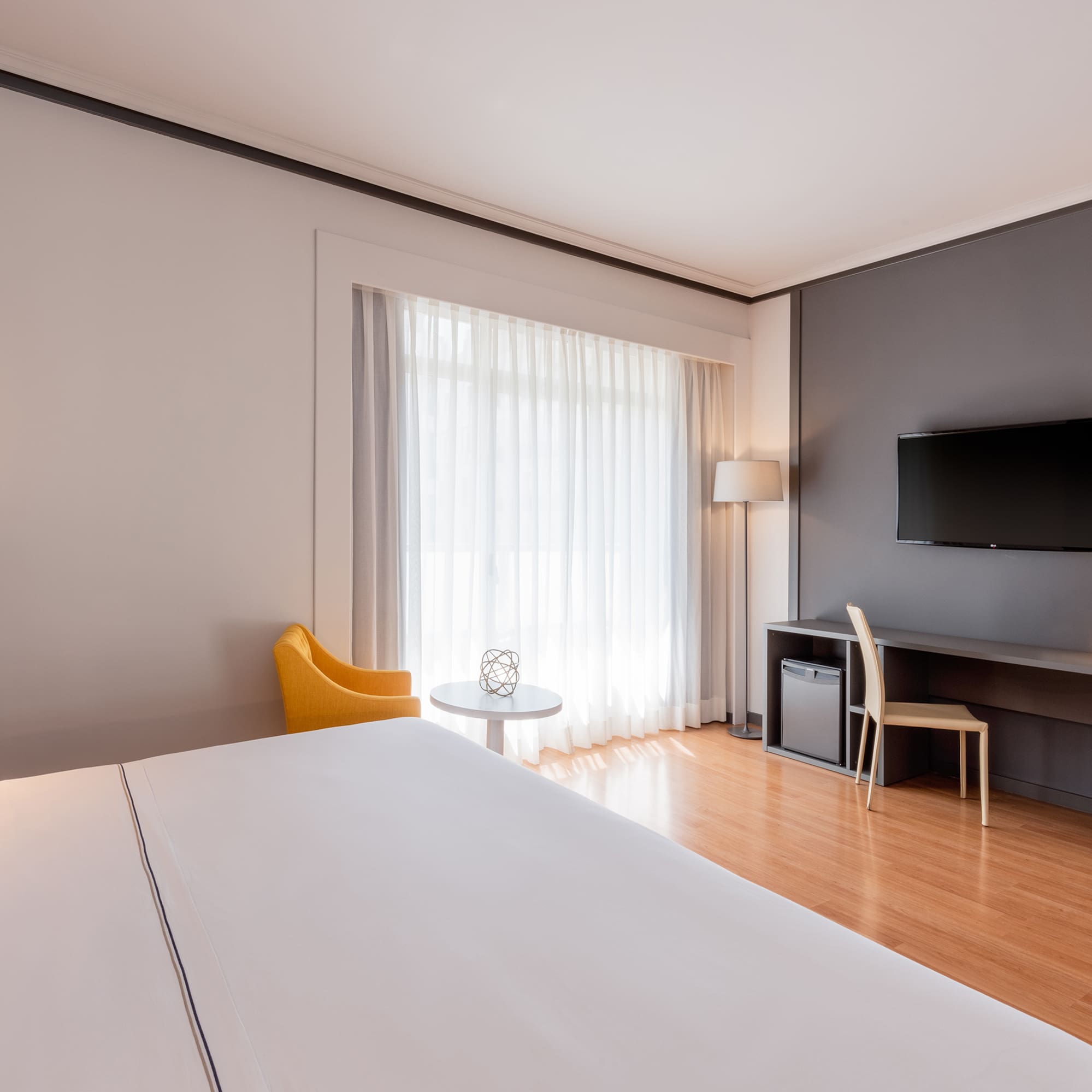 a room with a bed and a television