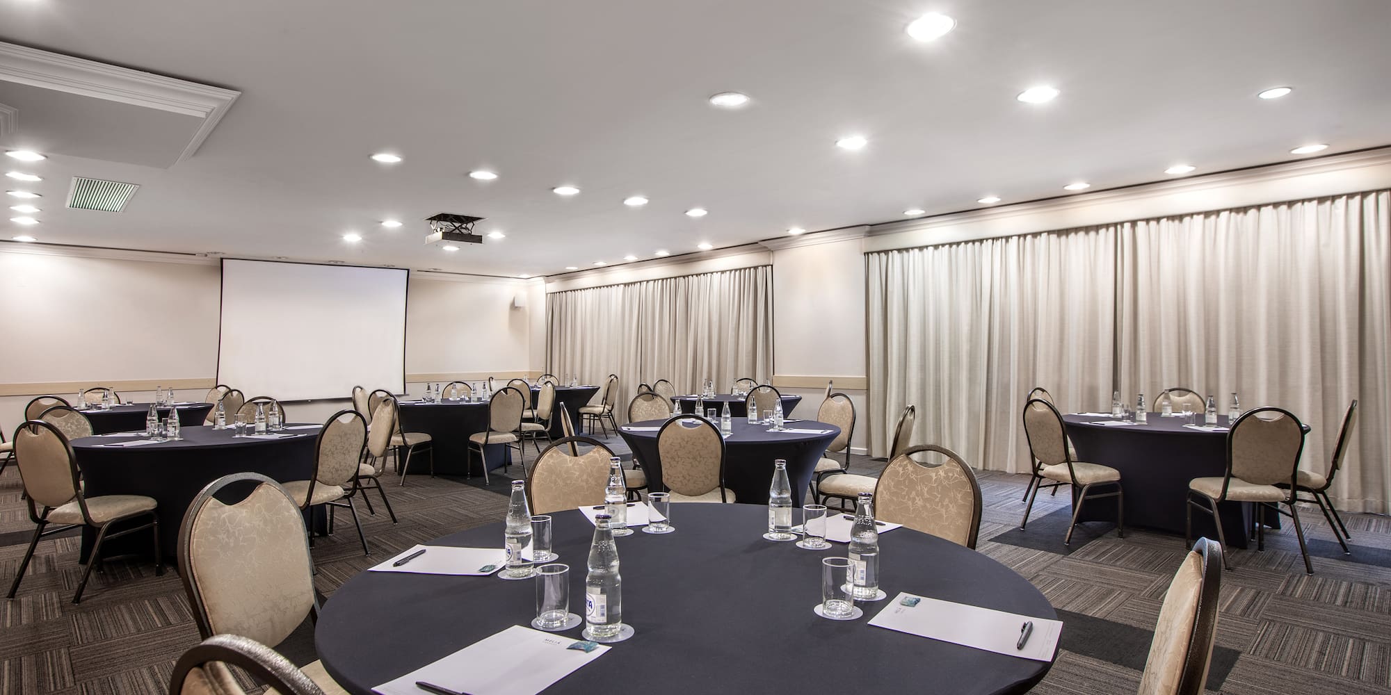 a room with round tables and chairs