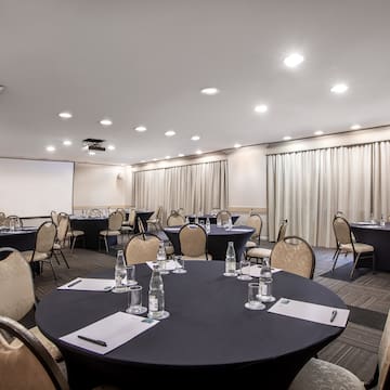 a room with round tables and chairs