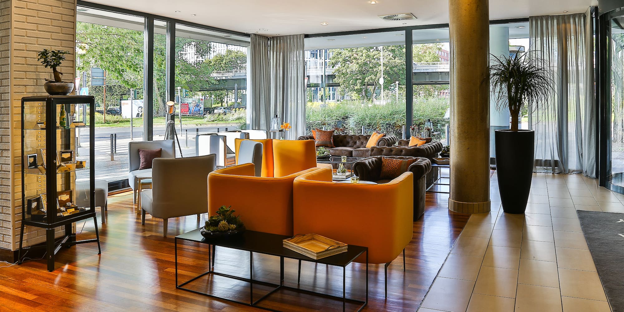 a room with a large window and a large couch