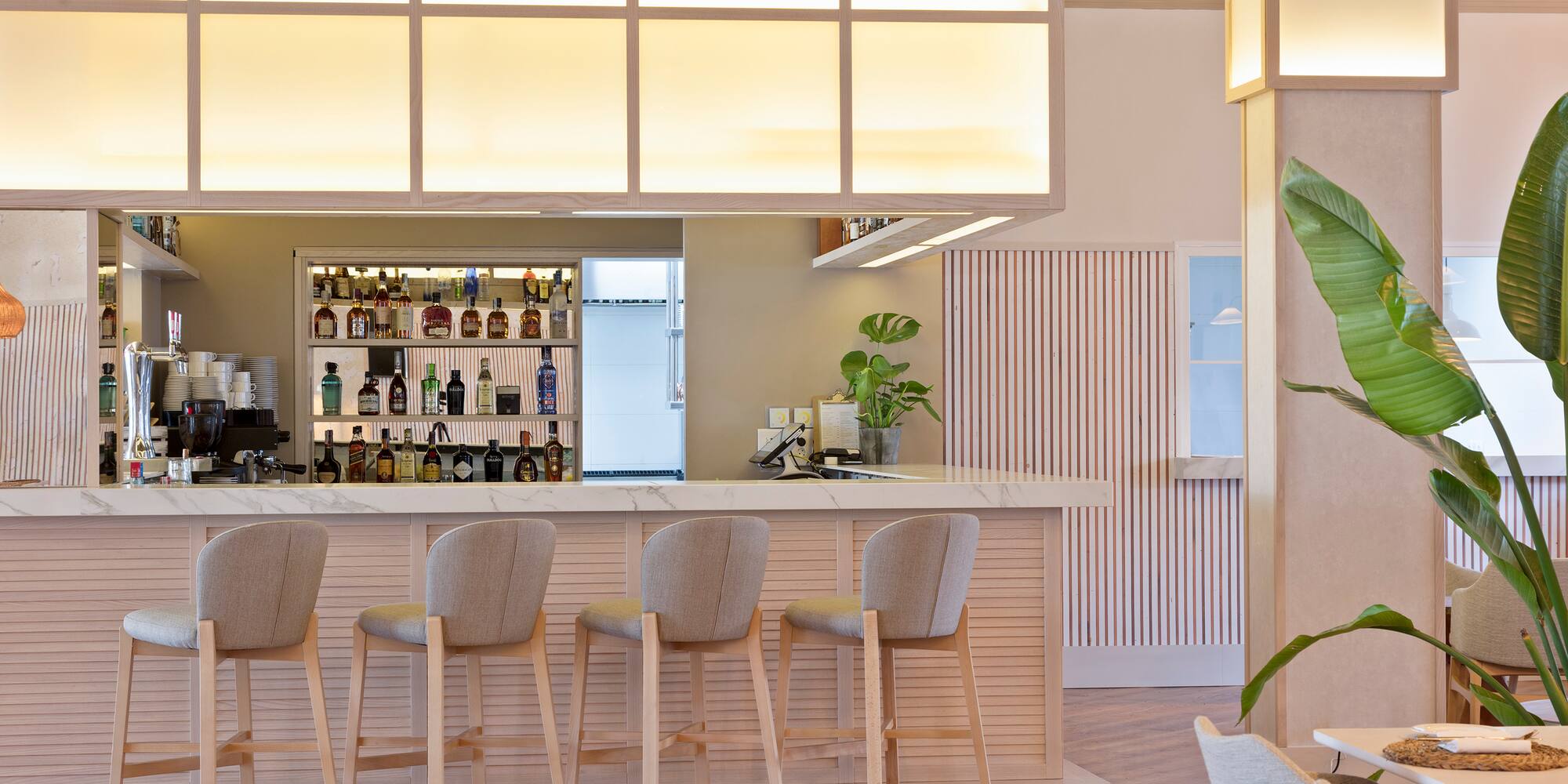 a bar with chairs and a counter