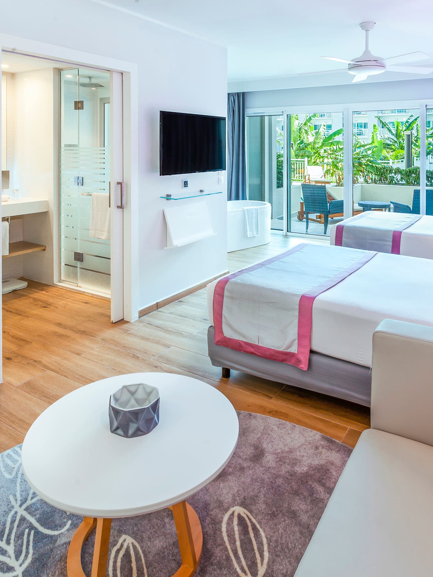 a room with two beds and a television