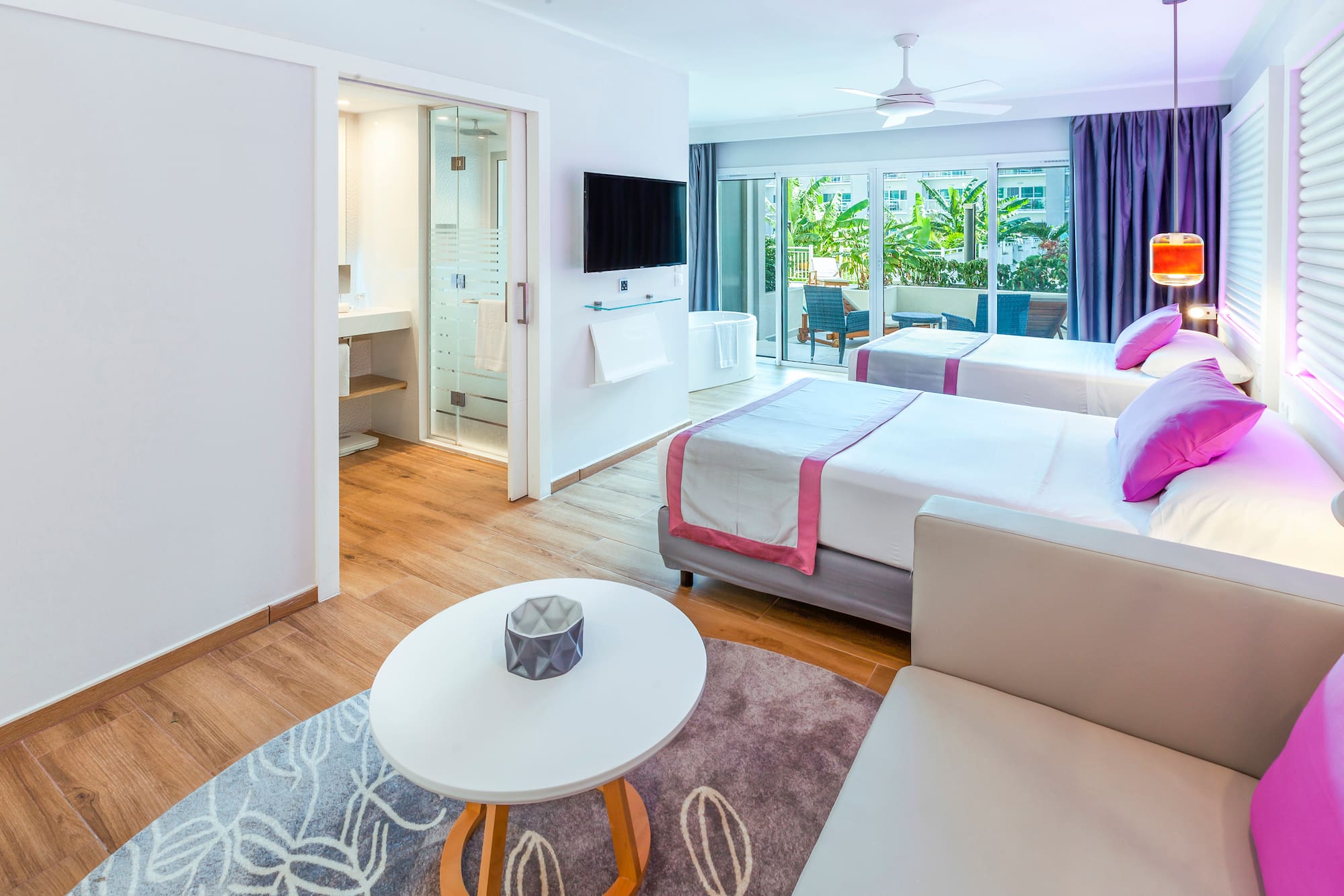 a room with two beds and a television