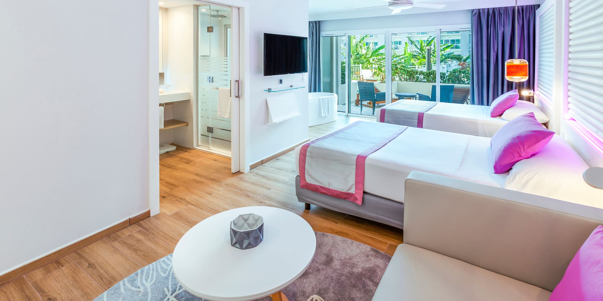 a room with two beds and a television