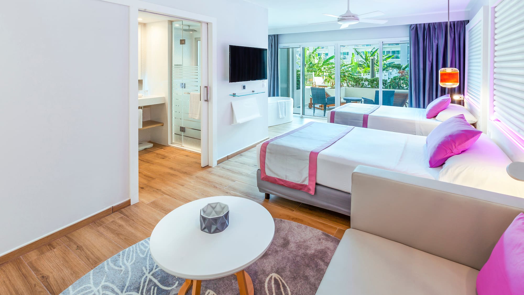 a room with two beds and a television