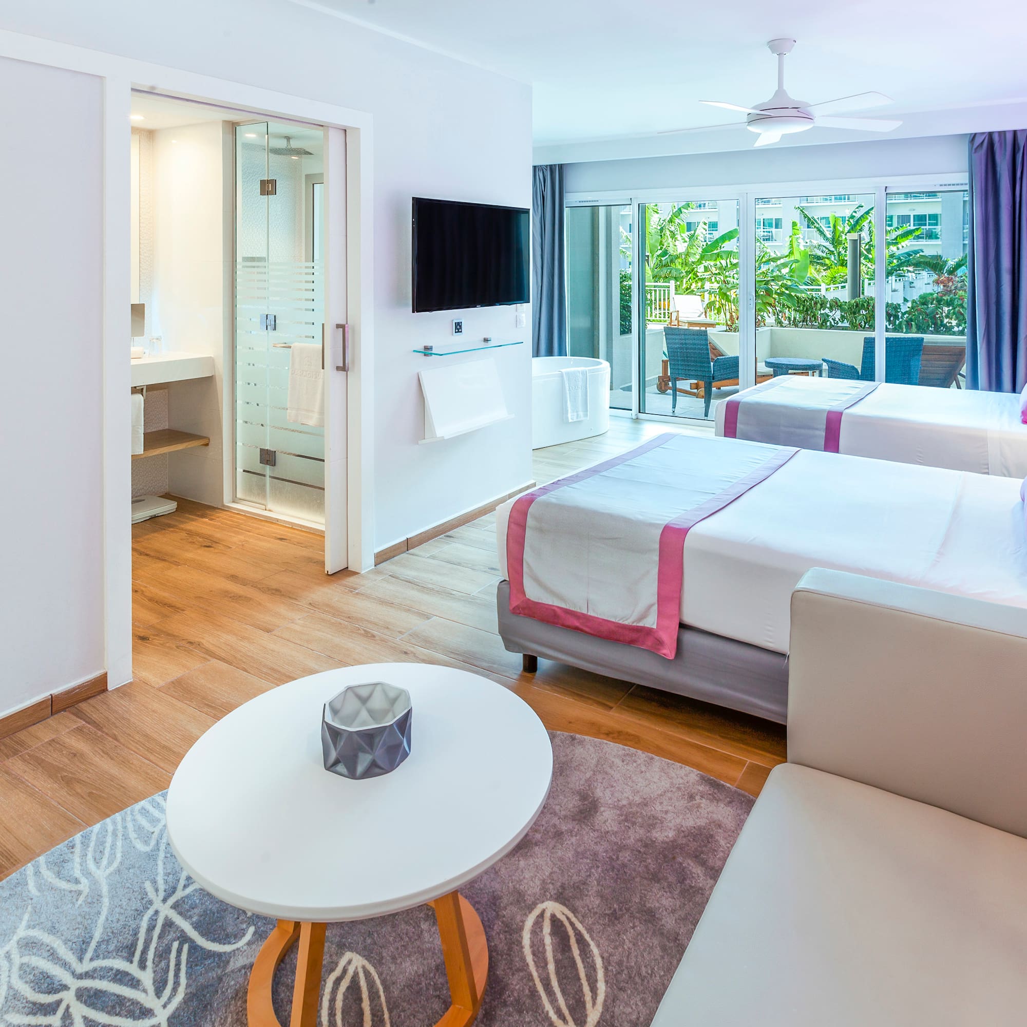 a room with two beds and a television