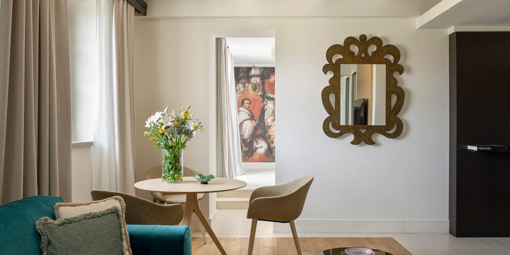 a living room with a blue couch and a mirror