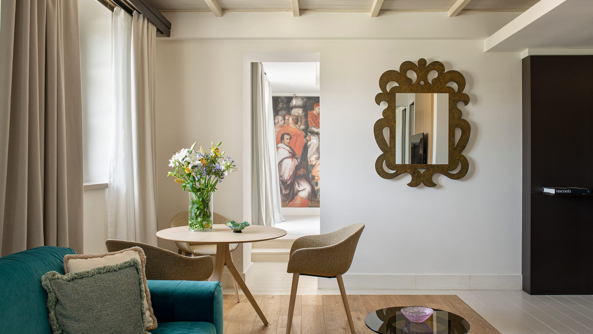 a living room with a blue couch and a mirror