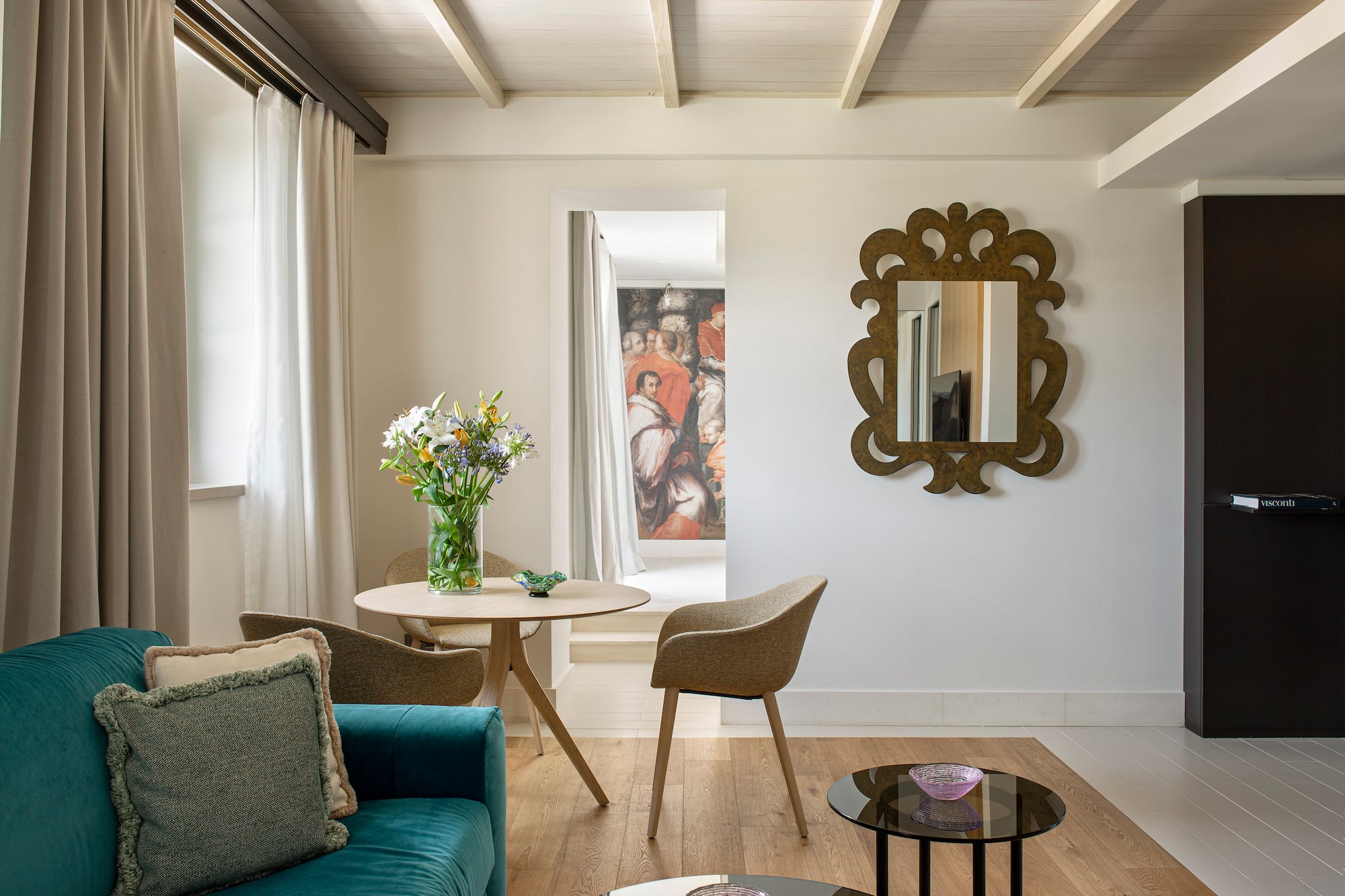 a living room with a blue couch and a mirror