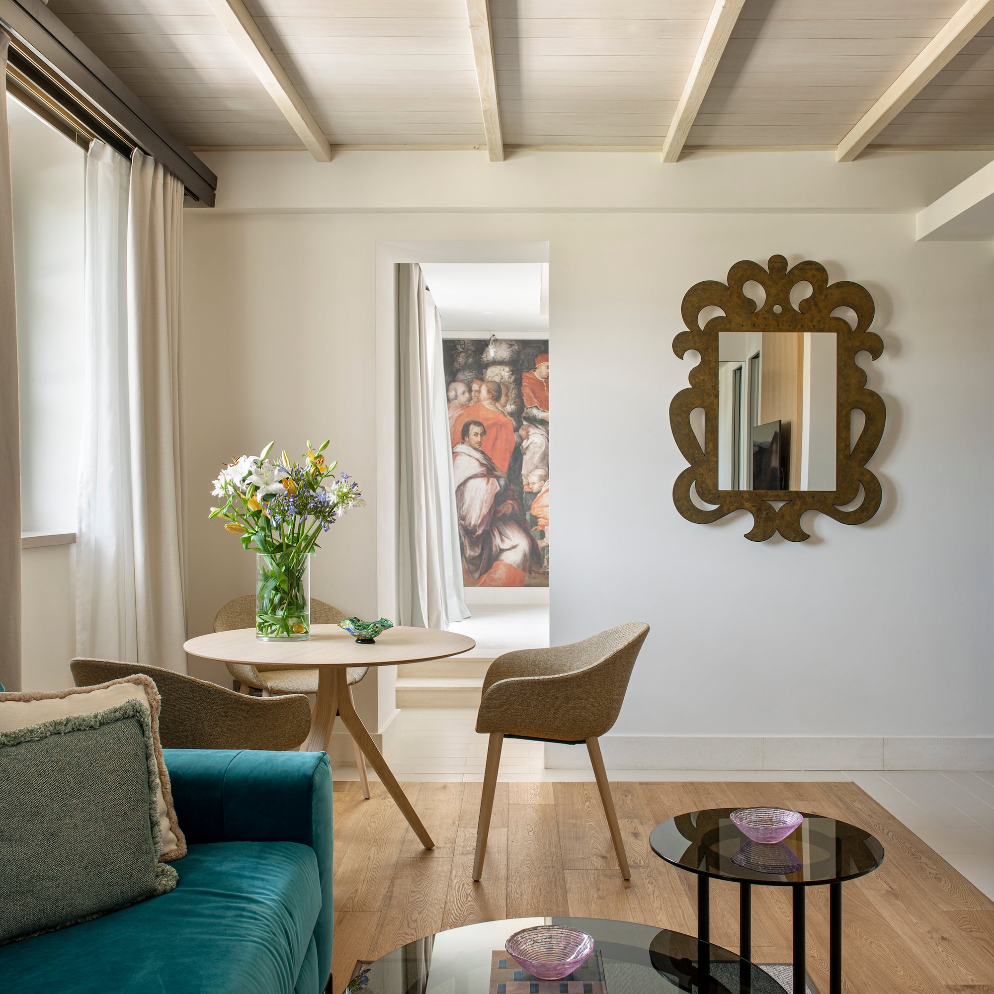 a living room with a blue couch and a mirror