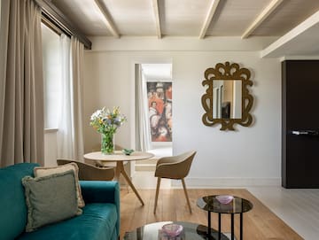 a living room with a blue couch and a mirror