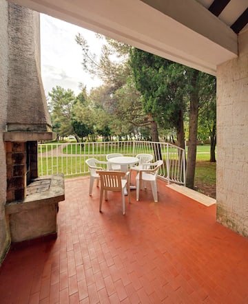 a patio with a table and chairs