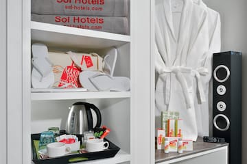 a shelf with towels and a tray of coffee