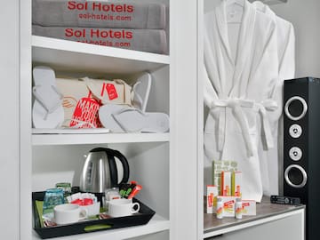 a shelf with towels and a tray of coffee