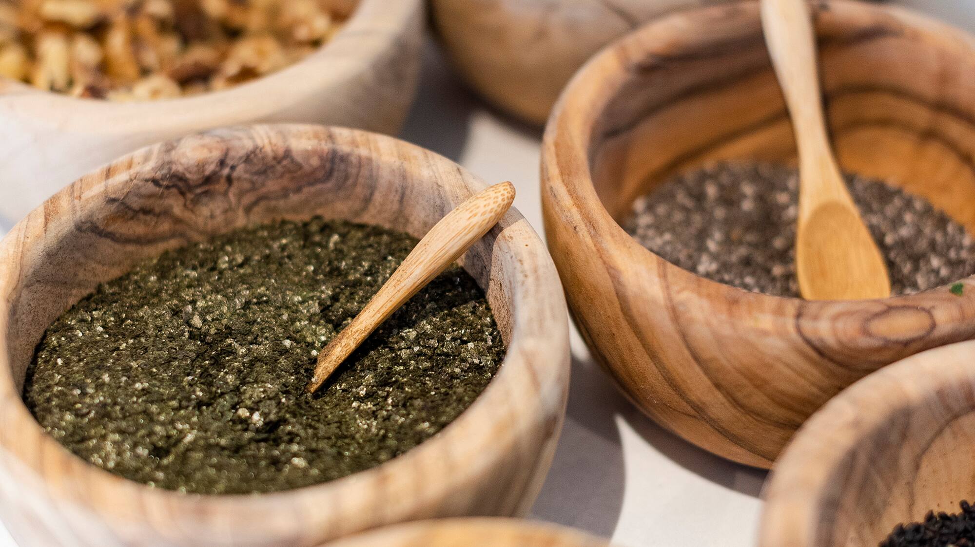 a group of bowls with different types of spices