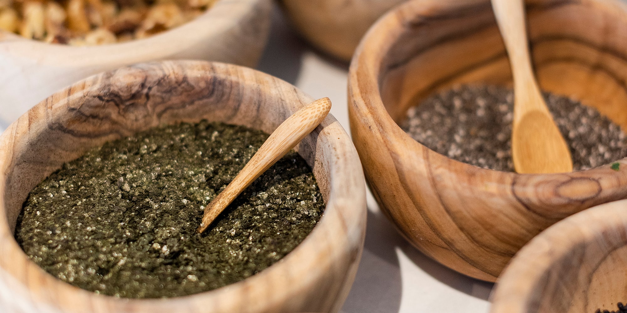 a group of bowls with different types of spices