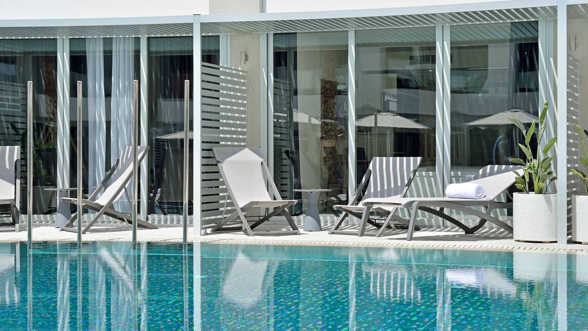 a pool with chairs and umbrellas