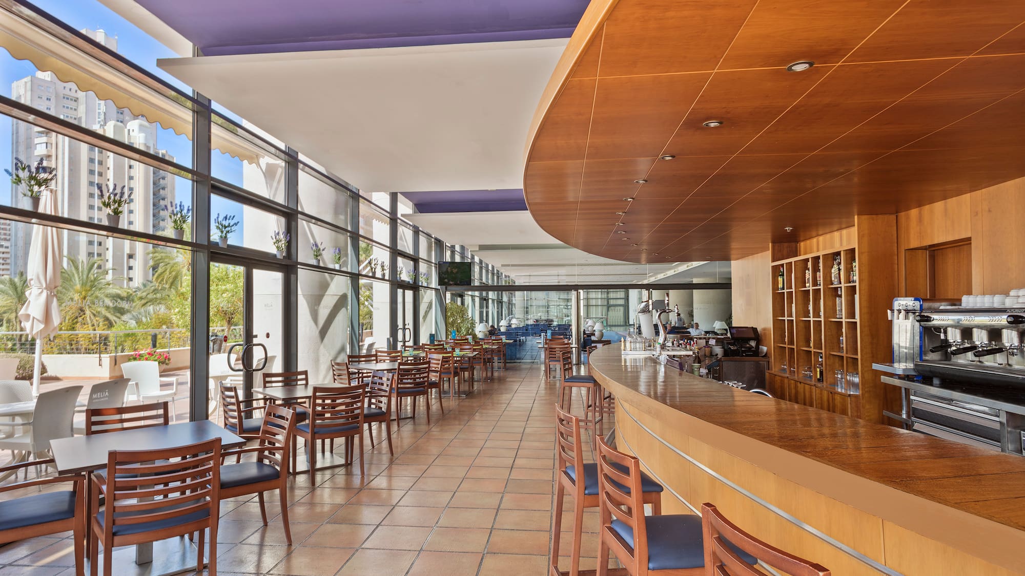 a room with a bar and chairs