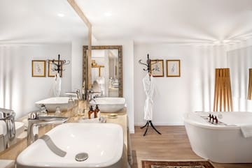a bathroom with a bathrobe and sinks