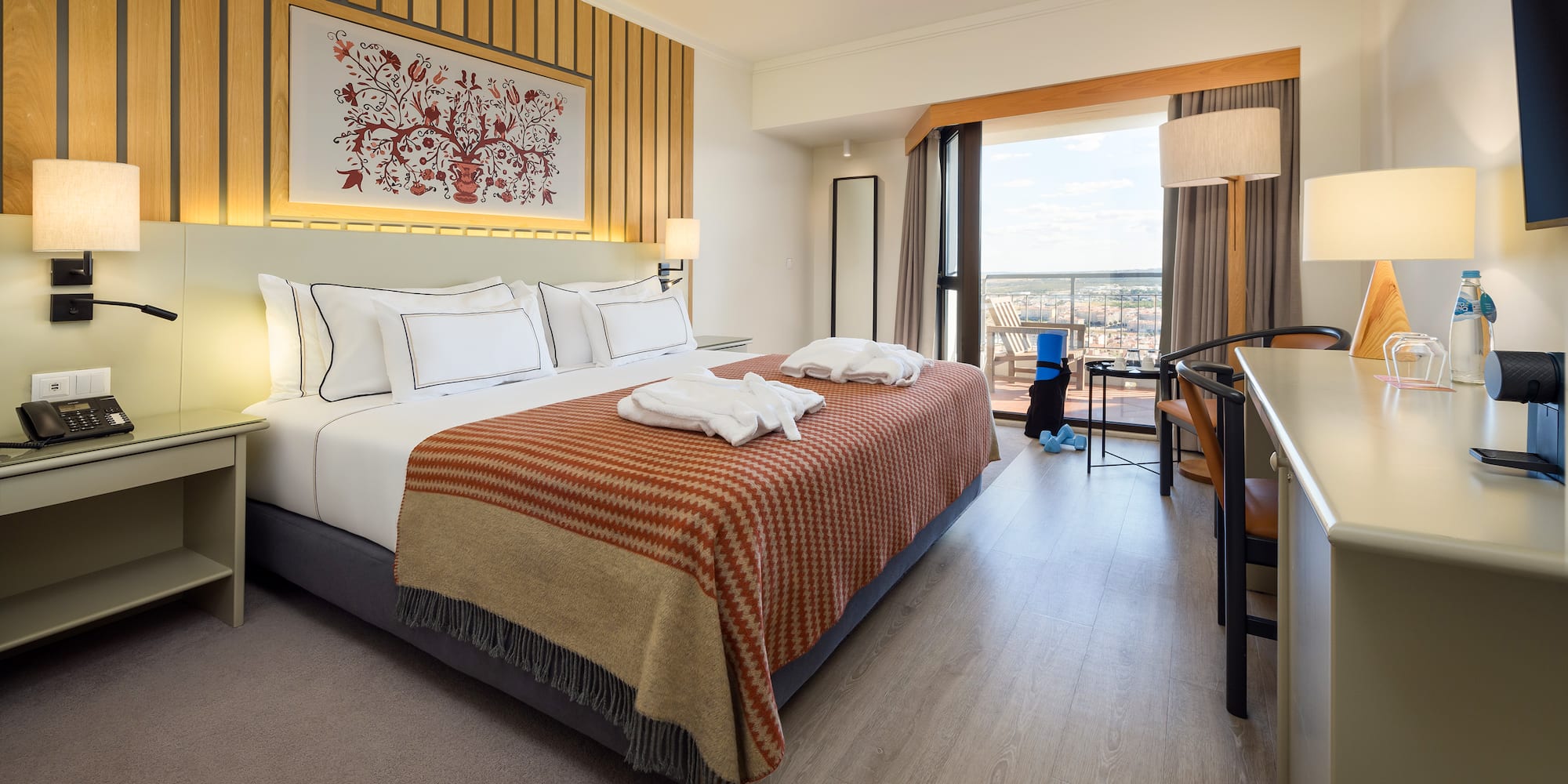 a hotel room with a bed and a desk