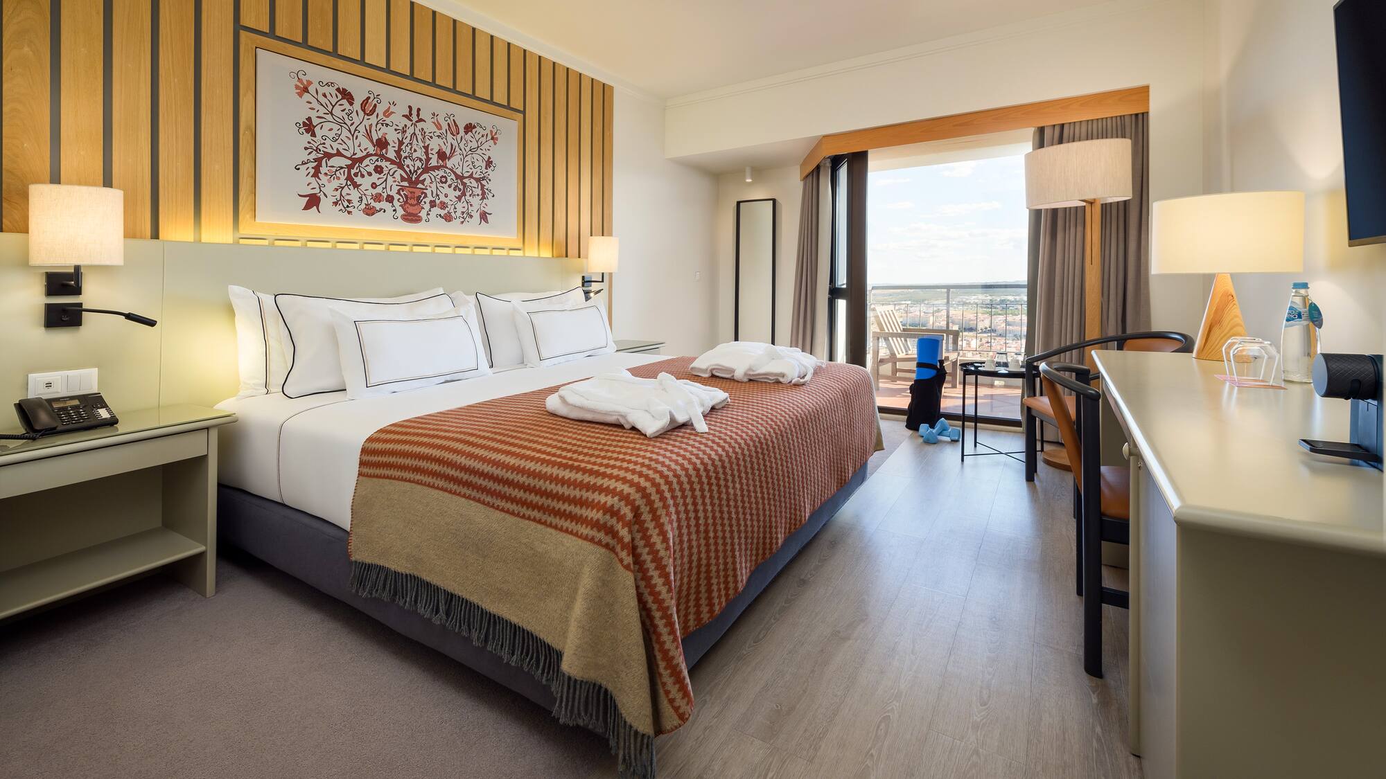 a hotel room with a bed and a desk