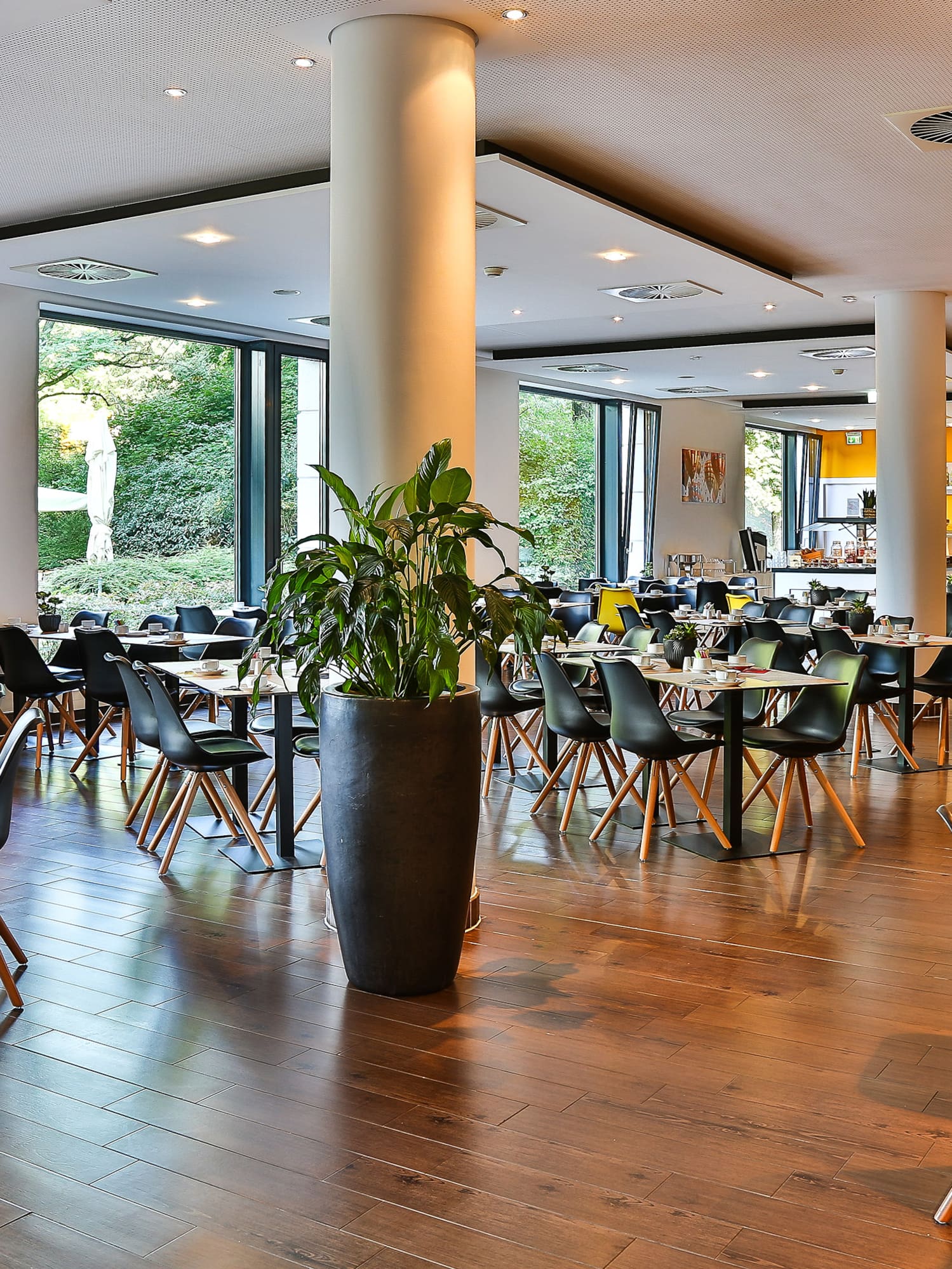 a room with tables and chairs and a clock