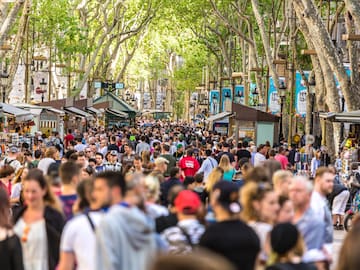 a crowd of people walking down a street